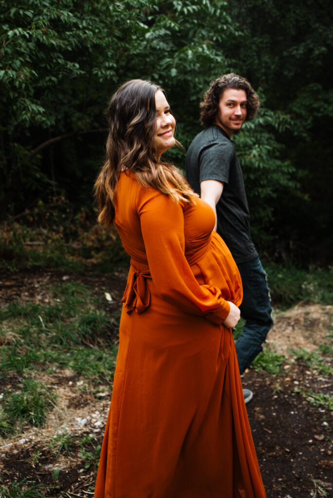 Summer Utah maternity session wearing orange dress