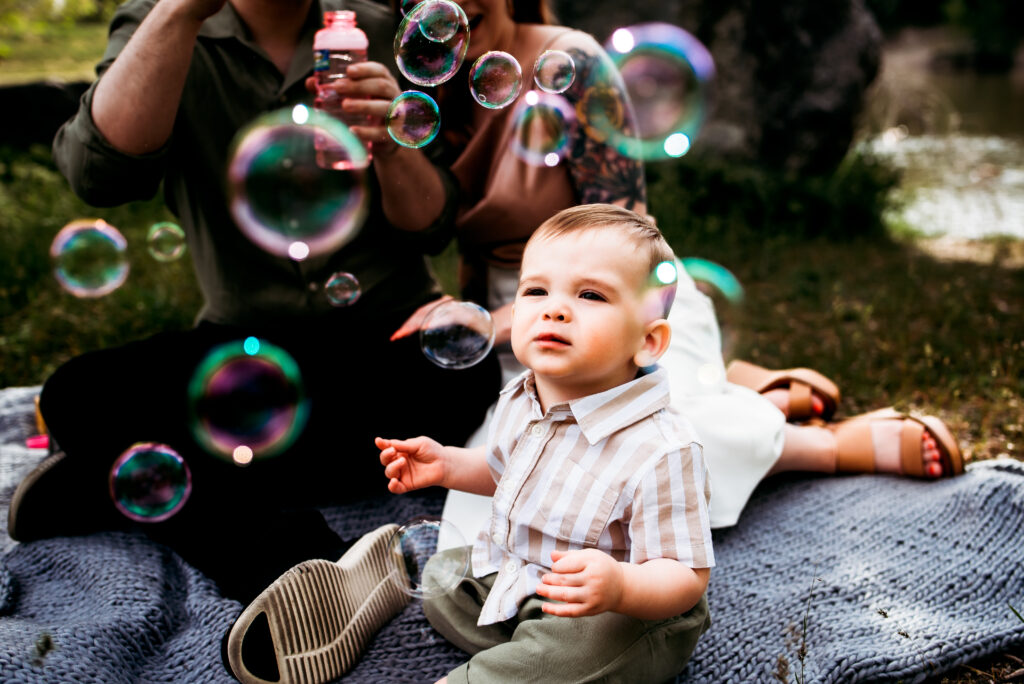 Mom blowing bubbles for baby during Utah family photos