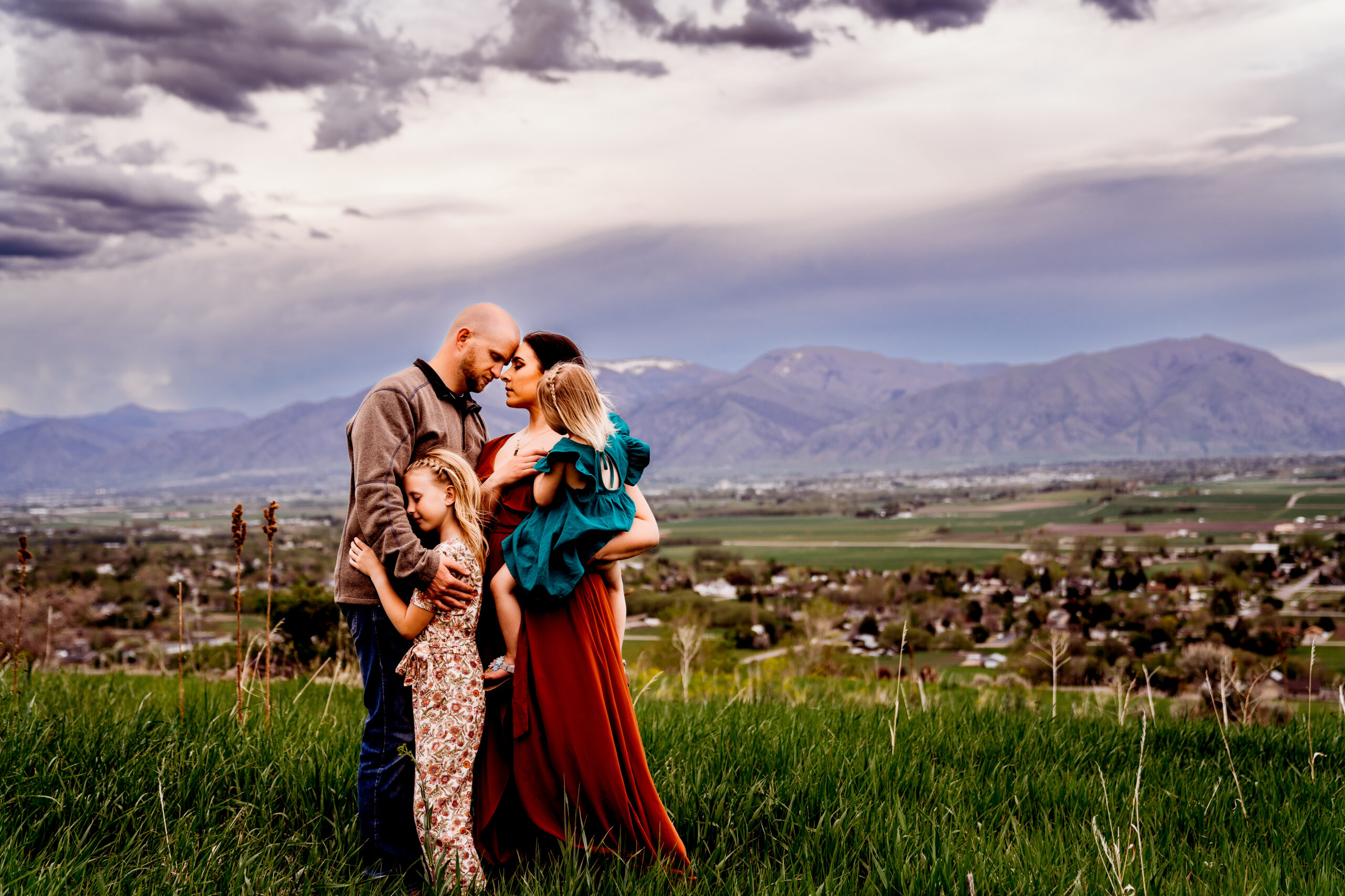Utah family photographer Katie Blakeley with husband and children in Wellsville mountains